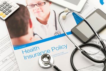 health insurance pamphlet and stethoscope