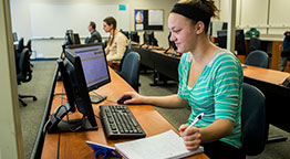 A female student working at a computer