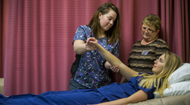 Students practicing skills used as a nursing assistant