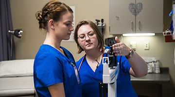 Students practicing taking the weight of a patient