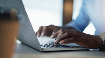 Hands typing on a keyboard