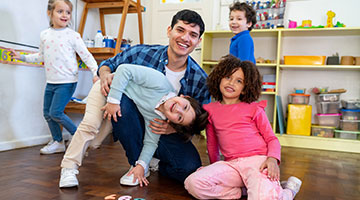 Diverse group of preschool kids with male teacher