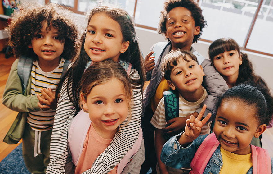 Preschool kids taking a picture together in a classroom