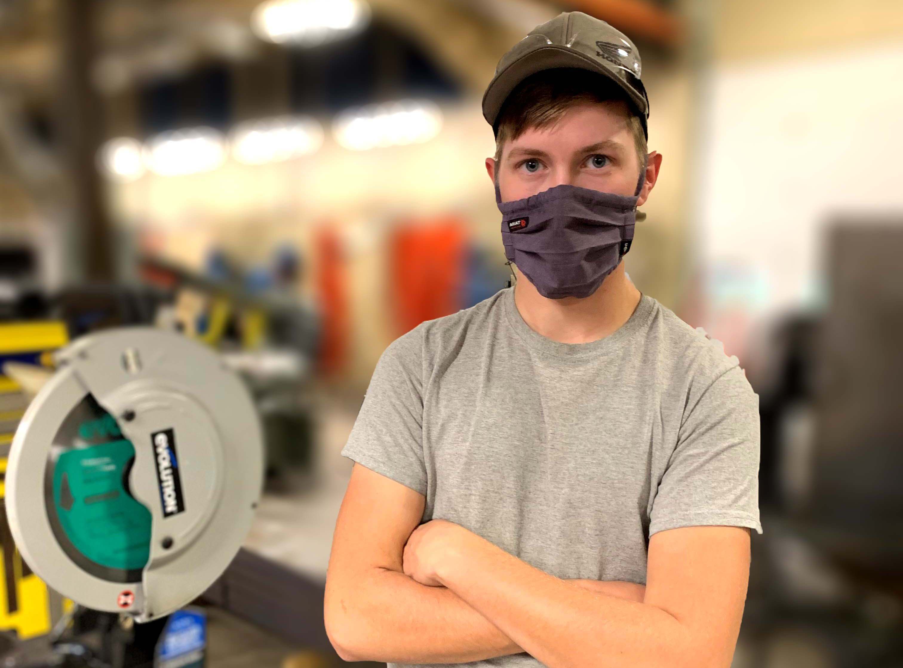 A welding student wearing a mask