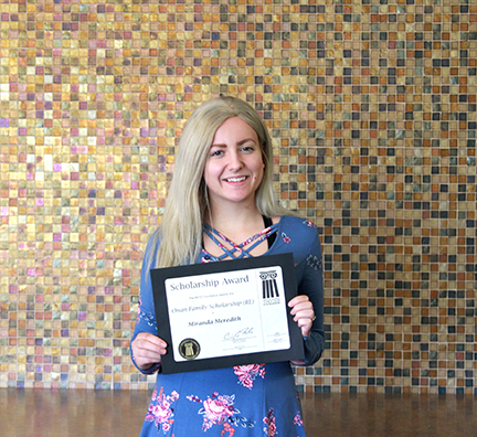 A WITC scholarship recipient holding their award
