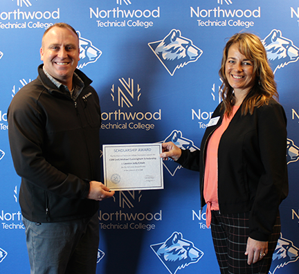 A WITC scholarship recipient holding their award