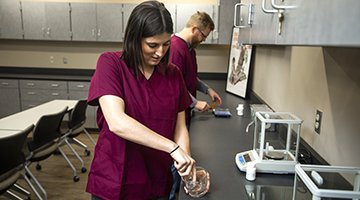 A pharmacy technician compounding medications