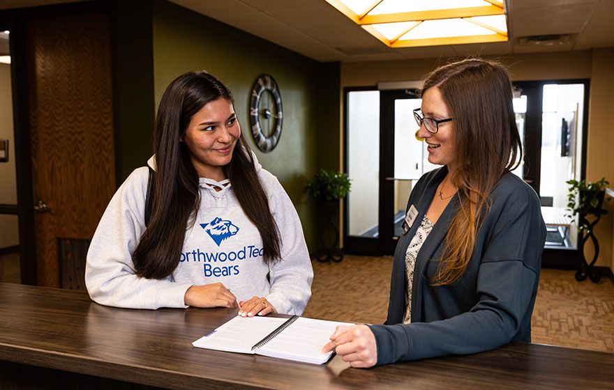 Student Services and student going through work study duties