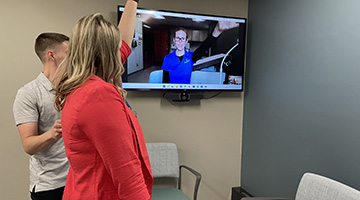 Students practices skills in a telehealth space