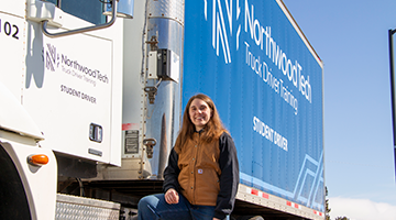 Northwood Tech Truck Driving students standing outside the semi truck