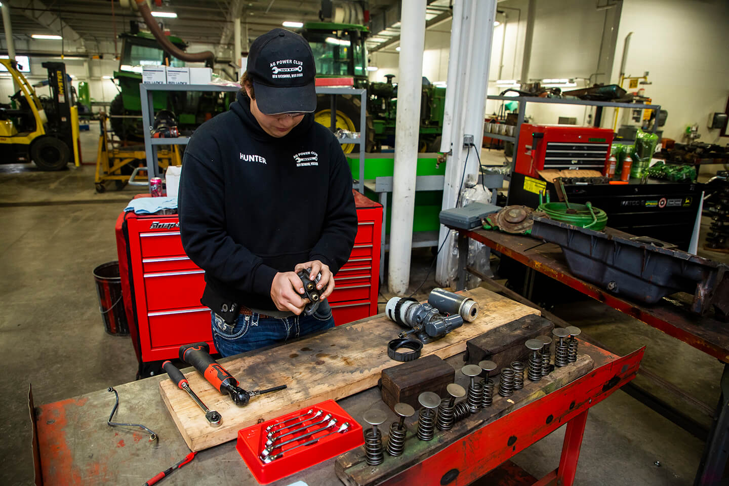 A student working with engines in the shop