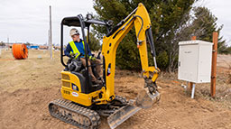 A utility construction worker using the machinery that is used in the industry