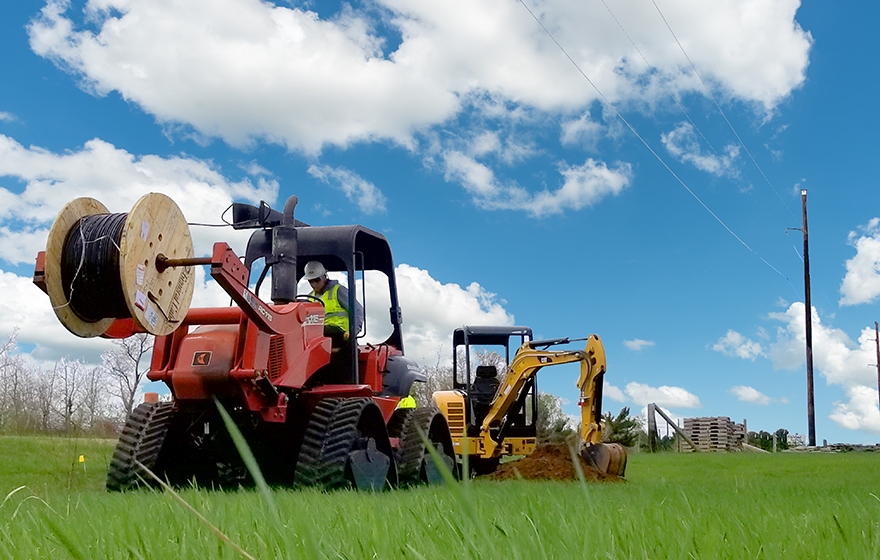 Utility construction technicians work outside installing utility systems