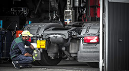 A diesel technician analyzing a semi truck