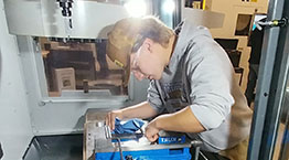 Student working on machine in classroom