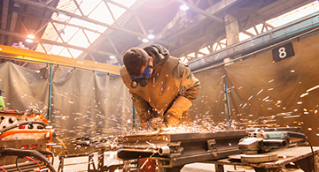 A welder working in the shop