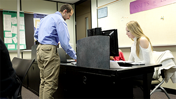 A WITC instructor talking with students in the classroom