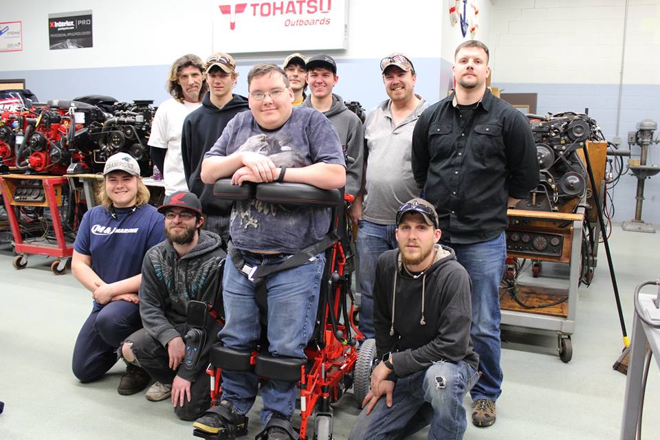 WITC student in new standing wheelchair surrounded by classmates