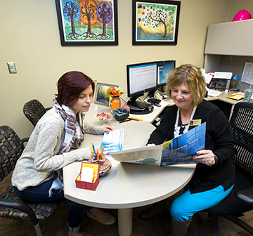 Student and WITC advisor sitting in an office at a table Student and WITC advisor sitting in an office at a table