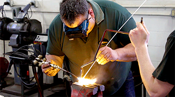 A student learning how to weld