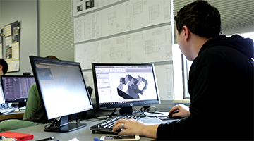 A student using architectural design software
