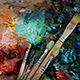 several paint brushes laying on a canvas with brightly colored paint, a modern abstract