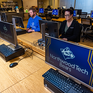 Students sitting at computers and working on their studies