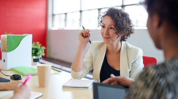 A business professional in a group meeting