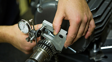 Close up of a hand working on a machine