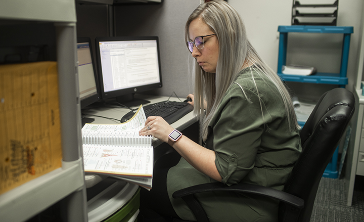 Medical coding student working on a computer