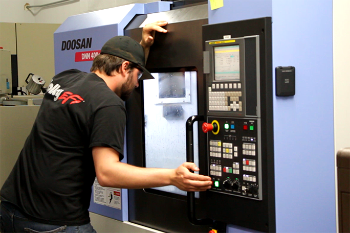 Student practicing using a CNC machine