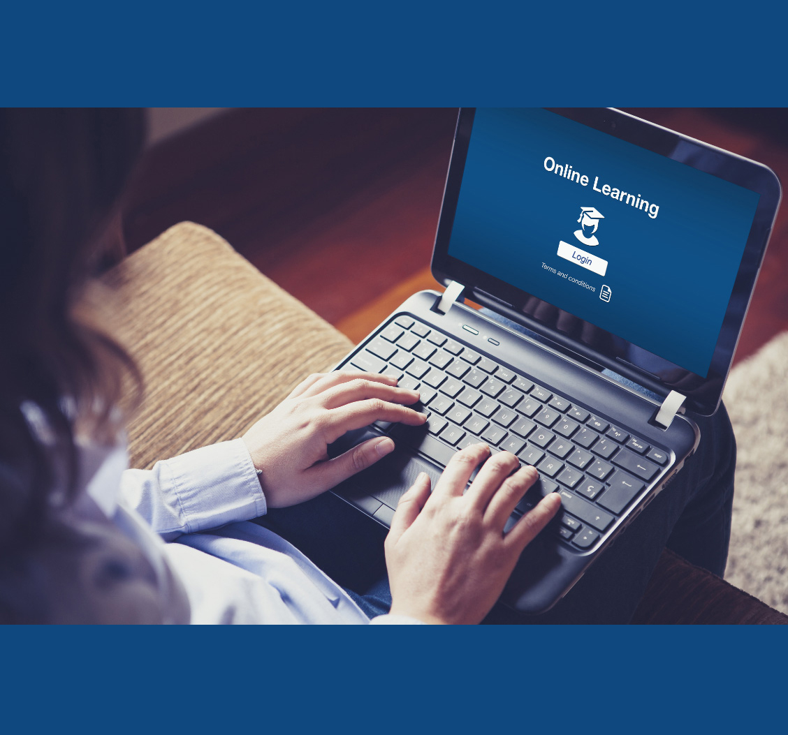 Online Learning Person working on a laptop with screen displaying 'online learning log in.'