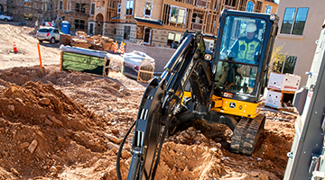 A utility construction worker using the machinery that is used in the industry