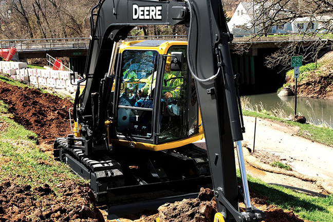 A utility construction working using heavy machinery