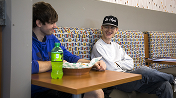 Two students talking and laughing 