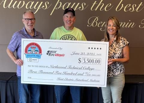 Dean Birman, Mike Podgornik, and Kim Pearson hold an oversized donation check for $3,500 made out to Northwood Technical College