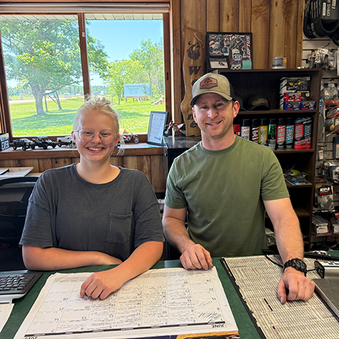 Northwood Tech alum Caitlin Redinger and owner William Whiting at Lone Wolf Marine’s front counter.