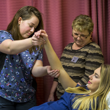 Student examining student's arm