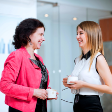 2 Employees having a side conversation and laughing