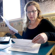 Female looking through a stack of papers