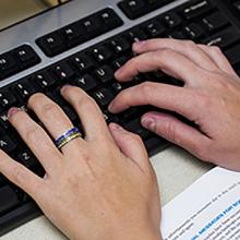 Hands typing on a keyboard