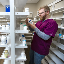 Student reading pill bottle