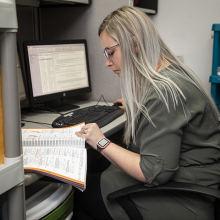 Student working on computer using notebook resources