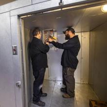 2 students working on a HVAC system