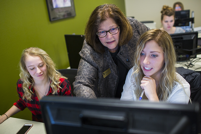 An instructor helping a student on the computer