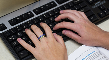 Hands typing on a keyboard