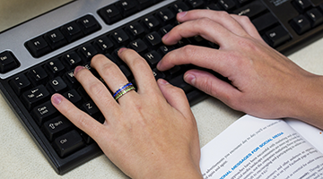 Hands typing on a keyboard