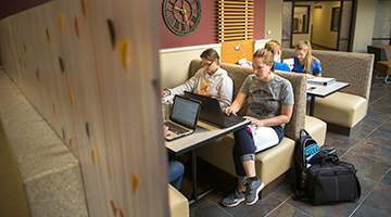 Students sitting in a booth and studying