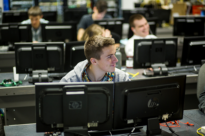An IT student sitting at the computer