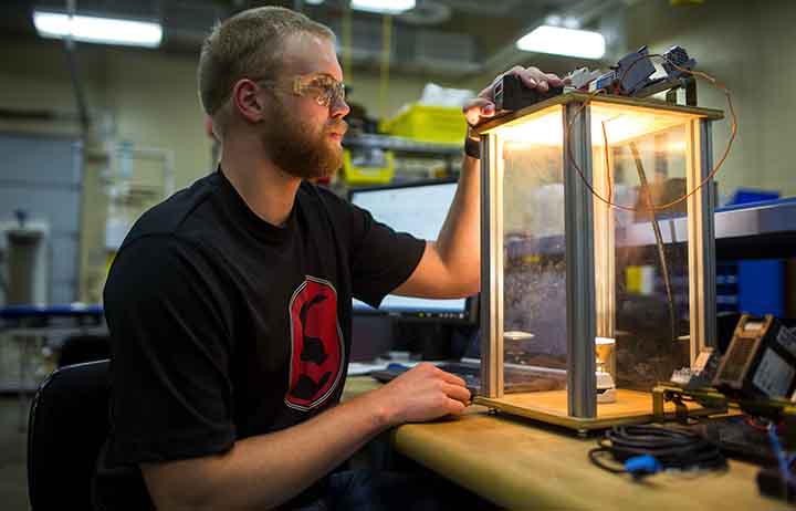 Student working with equipment in the automation lab